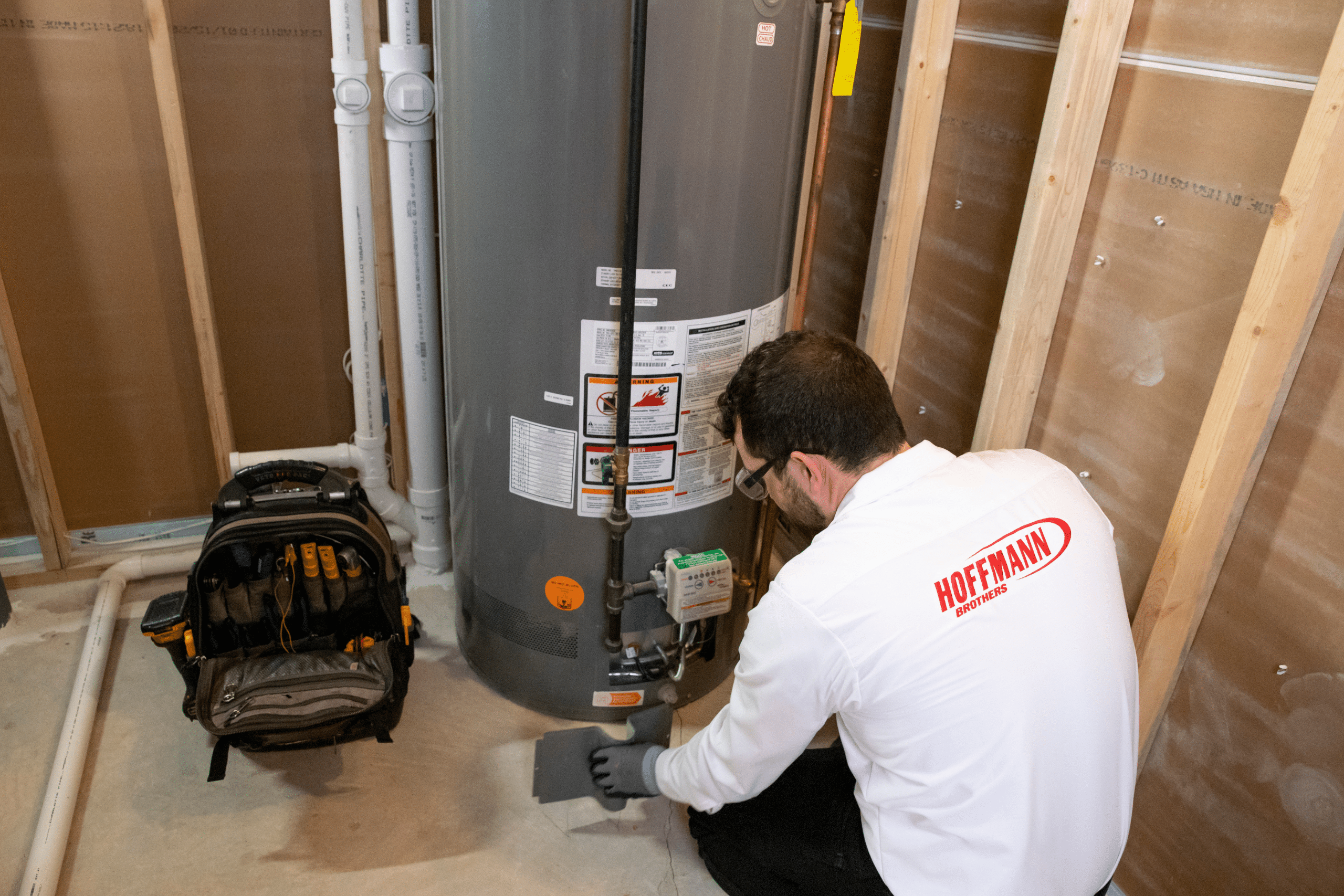 a Hoffmann expert repairing a water heater